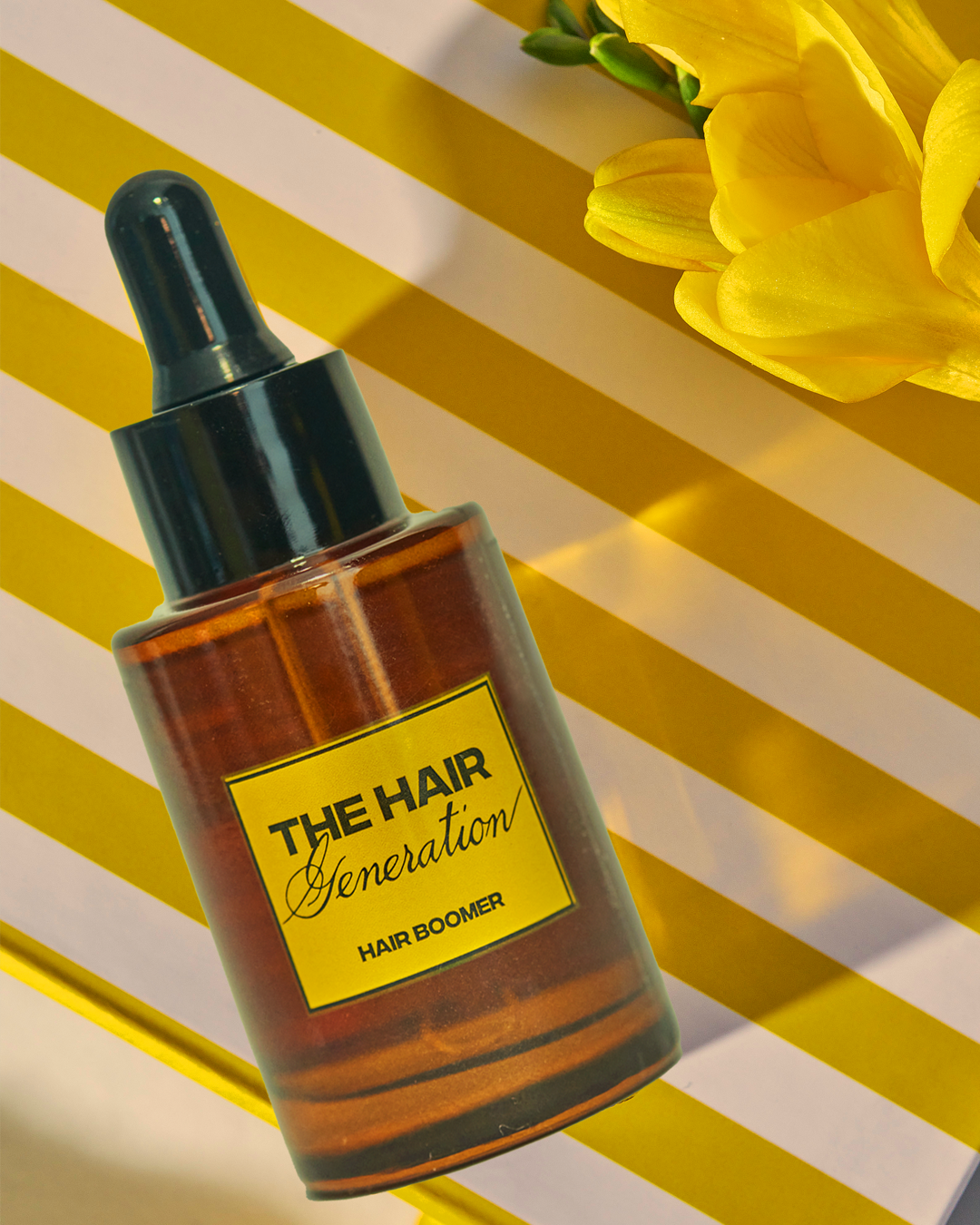 Bottle of 'The Hair Generation' hair product with a yellow label on a striped background