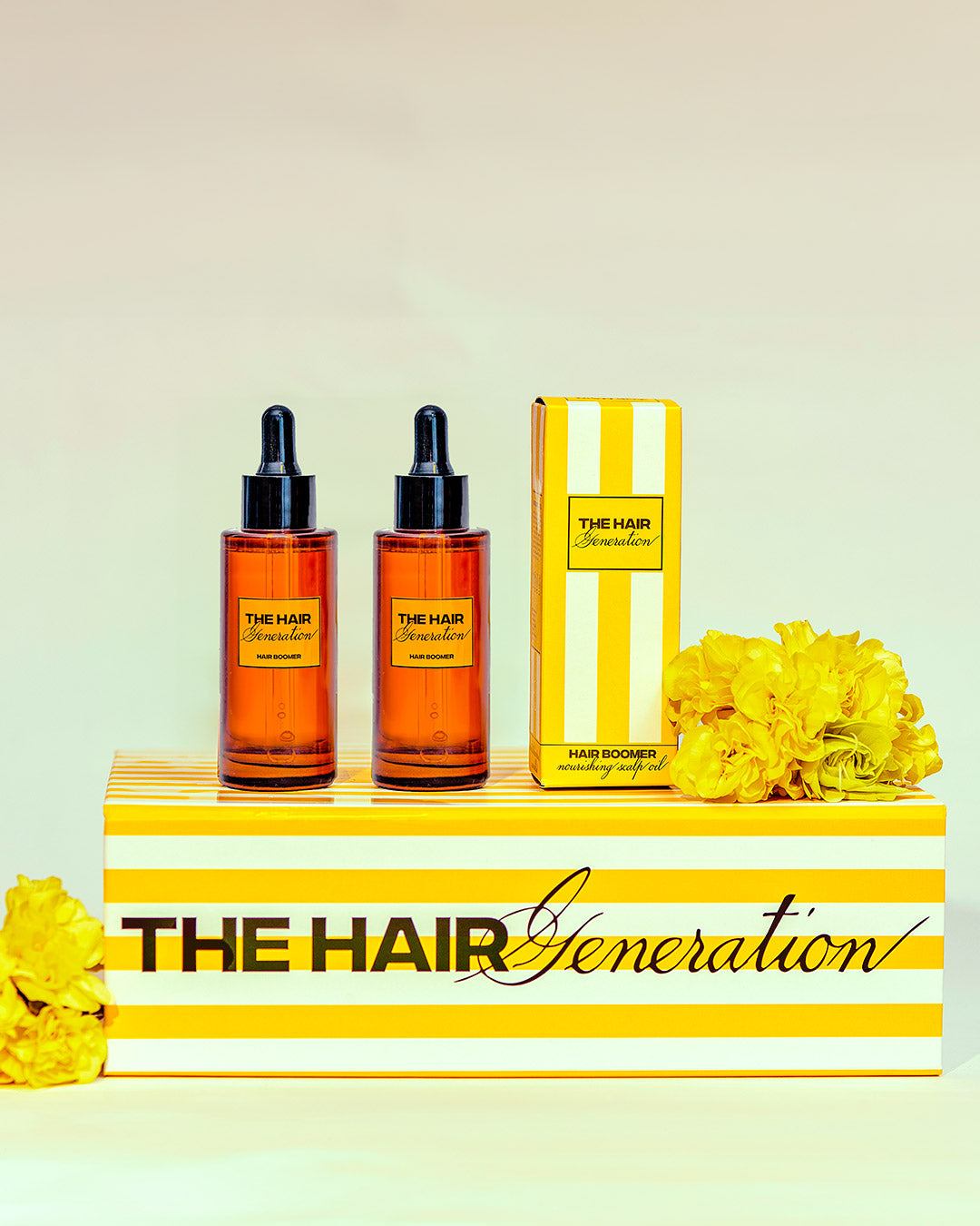 Two bottles and a box of 'The Hair Generation' product on a striped stand with yellow flowers.