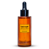 Amber glass bottle with black cap on a white background, featuring 'The Hair Generation' label.